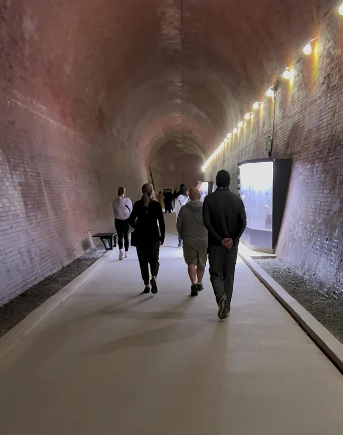 Tourists walk through a 2,200-foot tunnel that opens up to a close view of the falls. The tunnel was used to carry water used by the plant back into the river. (Colleen Thomas/TNS)