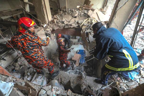 Fire officials look for survivors after an explosion in Dhaka, Bangladesh, on March 7, 2023. (Abdul Goni/AP Photo)
