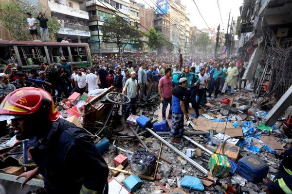 Onlookers gather outside the site of an explosion in Dhaka, Bangladesh, on March 7, 2023. (AP Photo)