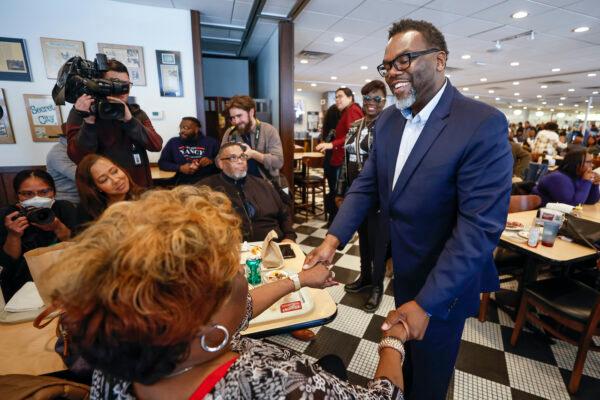 Mayoral candidate and Cook County Commissioner Brandon Johnson chats with a supporter inside Manny's Cafeteria and Delicatessen on City's Mayoral Election day on Feb. 28, 2023, in Chicago, Illinois. (Kamil Krzaczynski/Getty Images)