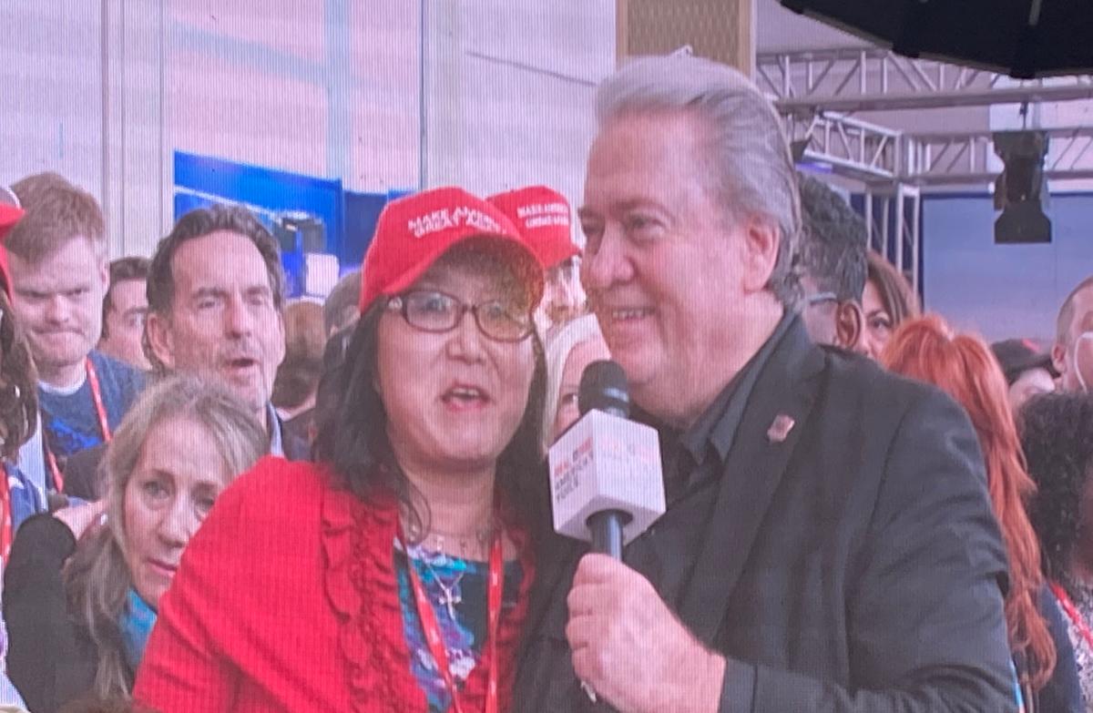 Stephanie Liu speaks with Steve Bannon during a live broadcast on Real America's Voice at CPAC on March 2, 2023. (Janice Hisle/The Epoch Times)