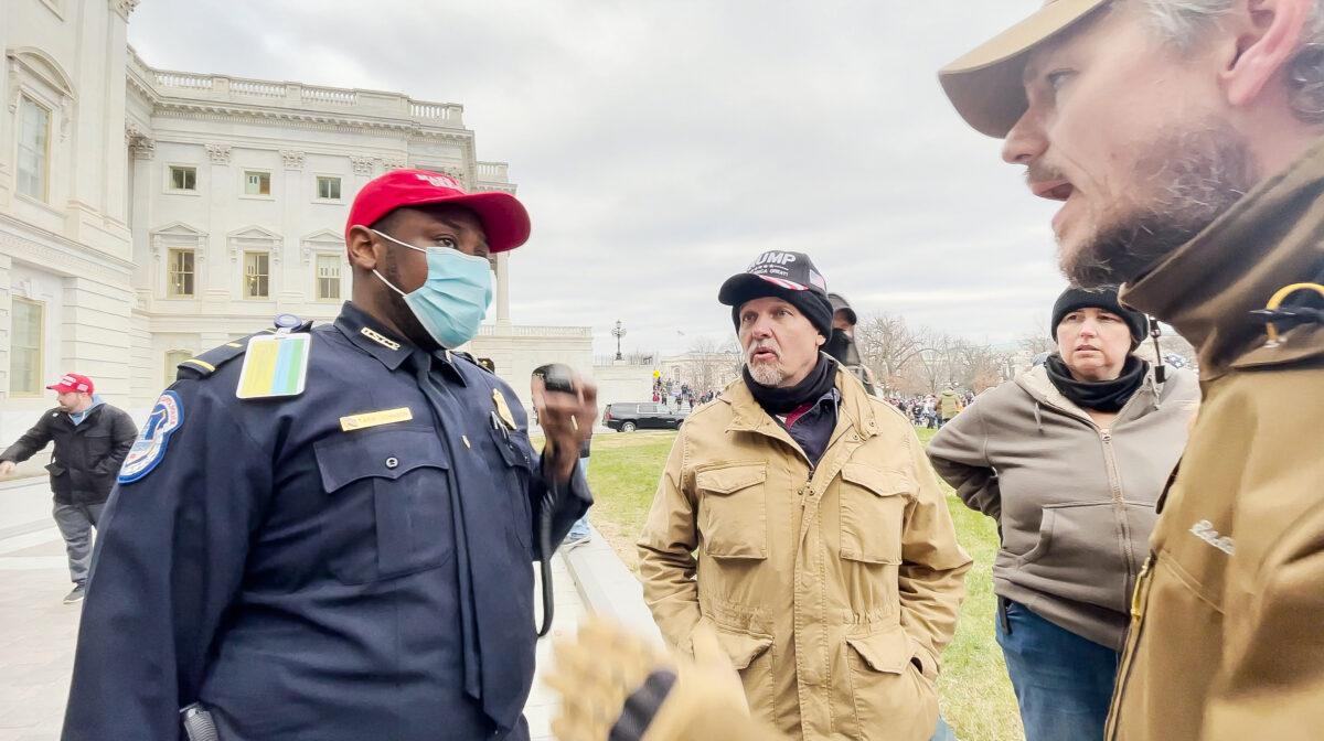 U.S. Capitol Police Lt. Tarik Khalid Johnson asks Oath Keepers Steve Clayton (center) and Michael Nichols for help rescuing police officers trapped inside the Capitol on Jan. 6, 2021. (Rico La Starza/Special to The Epoch Times)