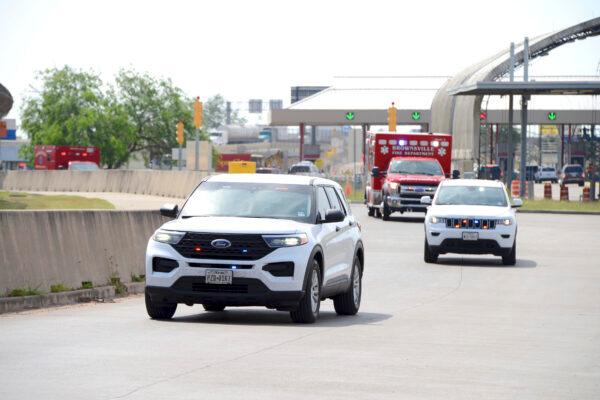 Two FBI vehicles escort two Brownsville Fire Department EMS Ambulances through Veterans International Bridge at Los Tomates with two surviving U.S. citizens being transported to Valley Regional Medical Center in Brownsville, Texas on March 7, 2023. (Miguel Roberts/The Brownsville Herald via AP)