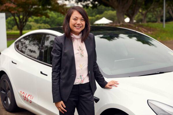 Supplied image of Origin e-mobility general manager Chau Le with an electric car in Sydney, Australia, on Nov. 4, 2022. (AAP Image/Supplied by Origin, Larnce Gold)