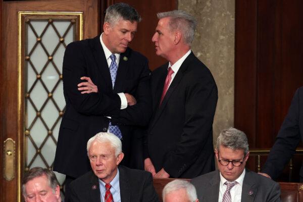 U.S. House Republican Leader Kevin McCarthy (R-Calif) (R) talks to Rep.-elect Darin LaHood (R-Ill.) in the House Chamber during the third day of elections for Speaker of the House at the U.S. Capitol Building in Washington, on Jan. 5, 2023. (Win McNamee/Getty Images)