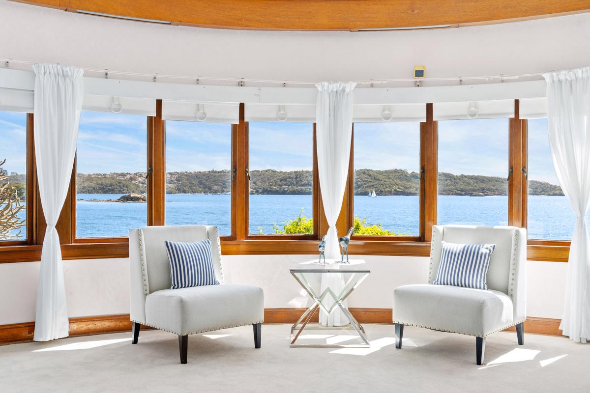 Sydney Harbour provides a dramatic yet relaxing backdrop to the home's living room. (Courtesy of Sydney Sotheby's International Realty)