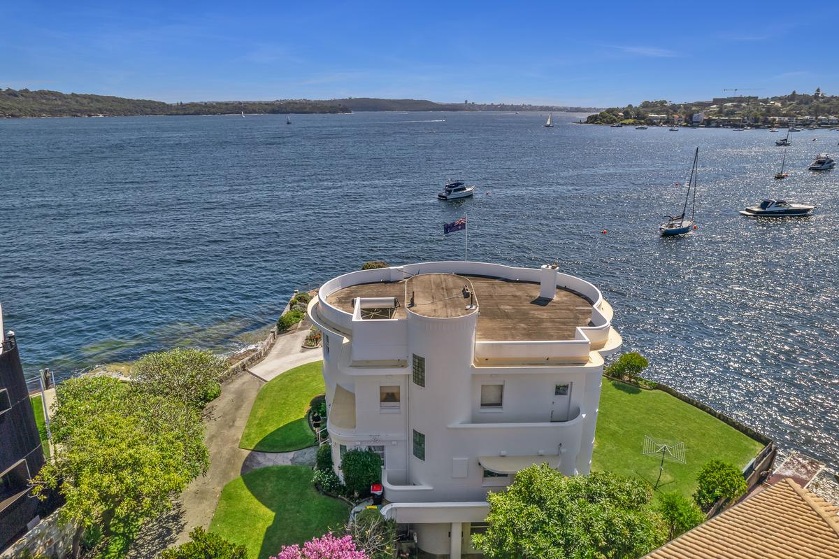 The residence, set at the water's edge, is buffered by a wide swath of lawn to ensure maximum privacy. (Courtesy of Sydney Sotheby's International Realty)