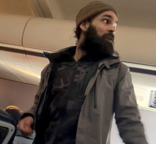 This still image from video shows a man who federal authorities have identified as Francisco Severo Torres as he moves through the cabin on a weekend flight from Los Angeles to Boston on March 5, 2023. (Lisa Olsen via AP)