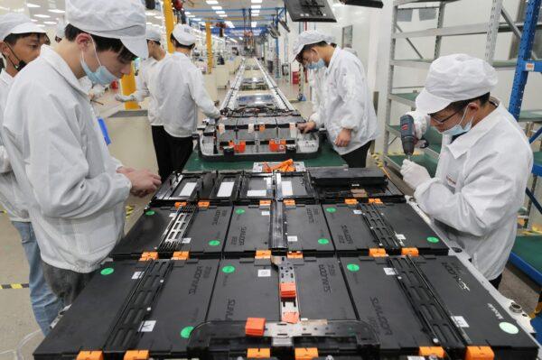 Workers at a factory for Xinwangda Electric Vehicle Battery Co., which makes lithium batteries for electric cars and other uses, in Nanjing in China's eastern Jiangsu Province, on March 12, 2021. (STR/AFP via Getty Images)