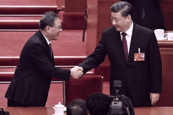 China's leader Xi Jinping (R) is congratulated by the second-ranked Li Qiang after being confirmed as the head of the state for a third term during the third plenary session of the National People's Congress in Beijing on March 10, 2023. (Noel Celis/AFP via Getty Images)