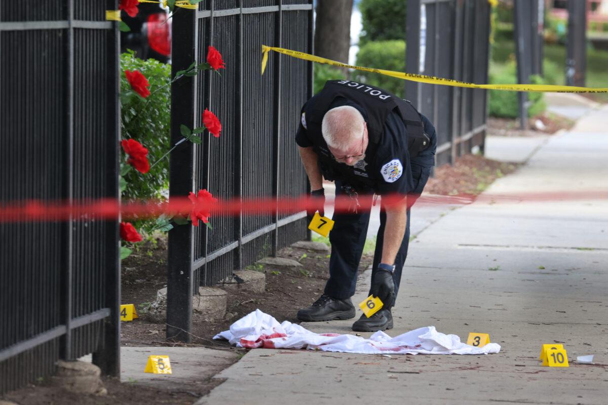 Police investigate a crime scene where three people were shot at the Wentworth Gardens housing complex in the Bridgeport neighborhood in Chicago on June 23, 2021. (Scott Olson/Getty Images)