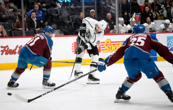 Los Angeles Kings right wing Adrian Kempe, center, fires the puck between Colorado Avalanche center Andrew Cogliano, left, and right wing Logan O'Connor in the second period of an NHL hockey game in Denver on March 9, 2023. (David Zalubowski/AP Photo)