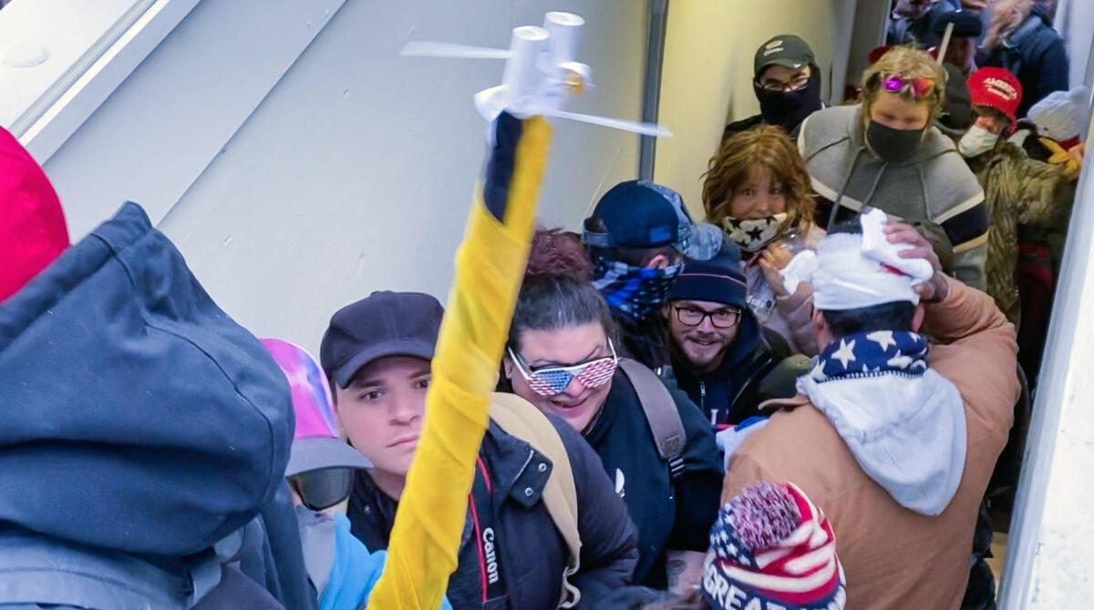 Rosanne Boyland (in the American flag glasses) heads up the stairs to the Lower West Terrace at the U.S. Capitol on Jan. 6, 2021. (Open Source Video/Screenshot via The Epoch Times)