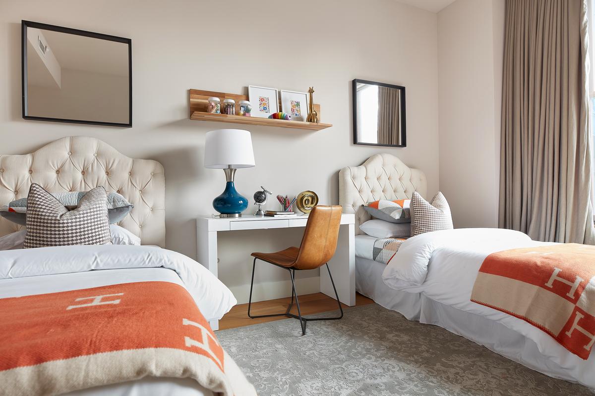 Bright orange throws are paired with an electric blue table lamp for a burst of unexpected color. (Scott Gabriel Morris/TNS)