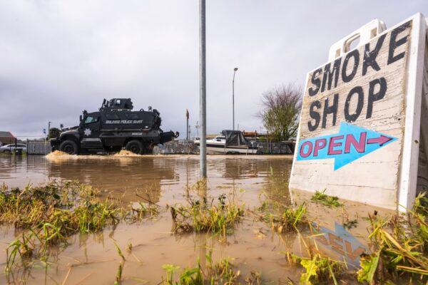 An armored SWAT vehicle drives through floodwaters in Watsonville, Calif., on March 11, 2023. (Nic Coury/AP Photo)