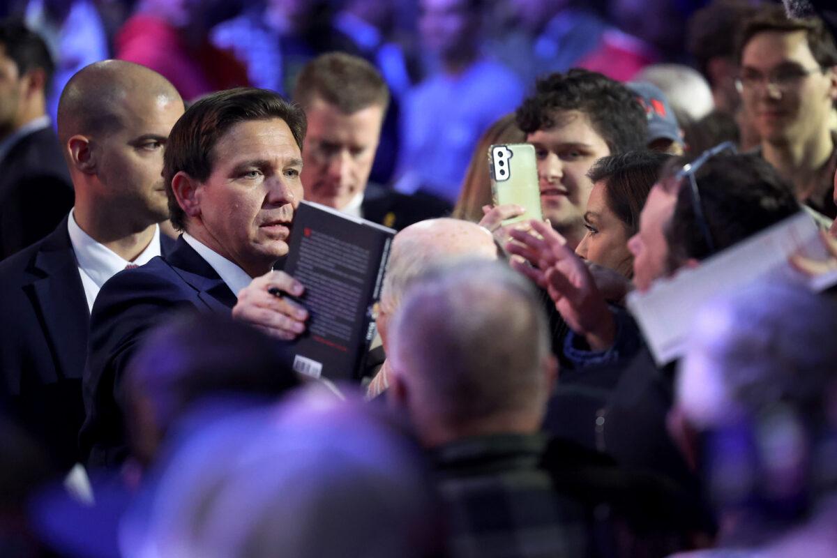 Florida Gov. Ron DeSantis signs copies of his book after speaking to Iowa voters during an event in Des Moines, Iowa, on March 10, 2023. (Scott Olson/Getty Images)