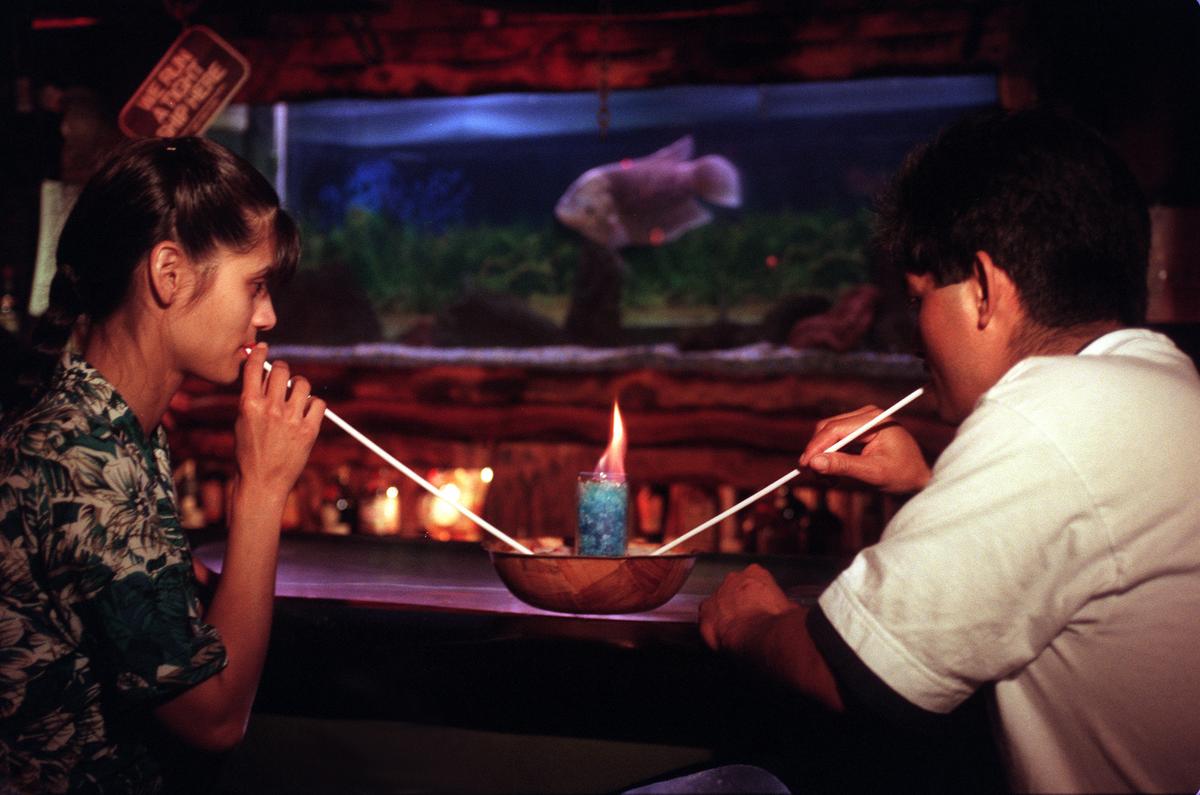 A young couple share a flaming honey bowl in 1997 at the now-closed Bahooka Ribs & Grog in Rosemead, California. (Genaro Molina/Los Angeles Times/TNS)