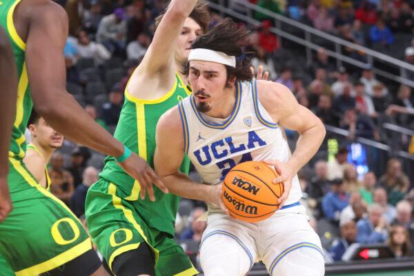 UCLA guard Jaime Jaquez Jr. (24) drives to the basket against Oregon center Nate Bittle during the first half of an NCAA college basketball game in the quarterfinals of the Pac-12 Tournament, in Las Vegas on March 10, 2023. (Chase Stevens/AP Photo/)
