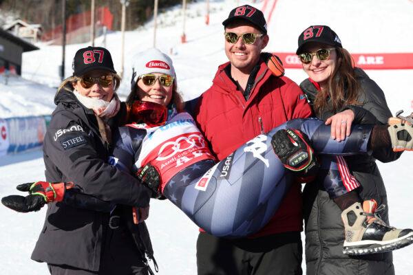 Brother Taylor, flanked by his wife Christie, right, and by her mother Eileen, left, holds the winner United States' Mikaela Shiffrin after an alpine ski, women's World Cup slalom, in Are, Sweden, on March 11, 2023. (Alessandro Trovati/AP Photo)