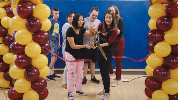 The school is a tuition free charter school that aims to help children with autism explore their unique gifts. Below, Harrison at a ribbon-cutting ceremony for the school’s post-secondary program focused on workforce training. (Courtesy of Arizona Autism Charter Schools)