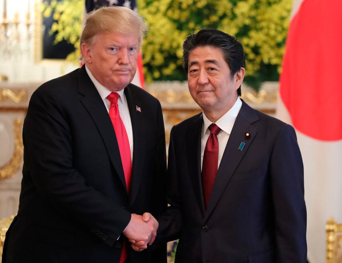 U.S. President Donald Trump (L) and Japanese Prime Minister Shinzo Abe shake hands prior to their meeting at Akasaka Palace, Japanese state guest house in Tokyo, Japan on May 27, 2019. (Eugene Hoshiko/Getty Images)