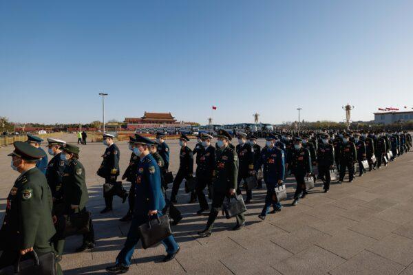 Delegates from China's armed forces arrive at the fifth plenary session of the National People's Congress in Beijing on March 12, 2023. (Lintao Zhang/Getty Images)