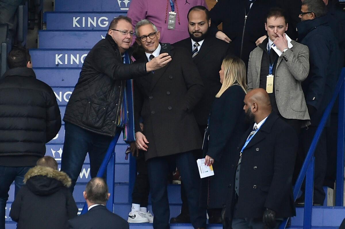 BBC's "Match of the Day" presenter Gary Lineker poses with a fan for selfies in the stands prior to the English Premier League soccer match between Leicester City and Chelsea at King Power stadium in Leicester, England, on March 11, 2023. (Rui Vieira/AP Photo)