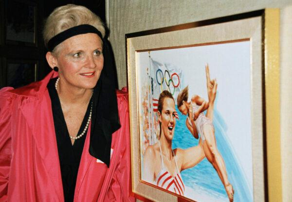 Pat McCormick stands in front of artwork of herself at the Olympic Hall of Fame in New York, Dec. 13, 1985. (Dave Pickoff/AP Photo)