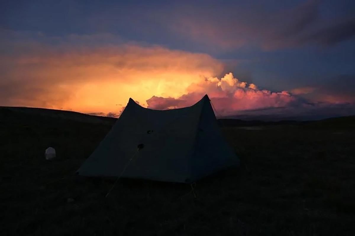 Clouds build as the sun sets over India Wood's tent during her walk across Colorado. (Courtesy of India Wood/TNS)