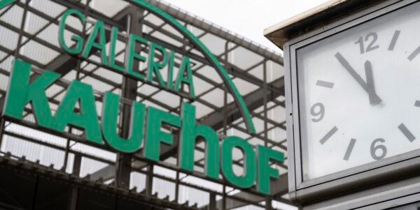A clock stands next to the logo of Galeria Kaufhof store in Chemnitz, Germany, on March 13, 2023. (Hendrik Schmidt/dpa via AP)