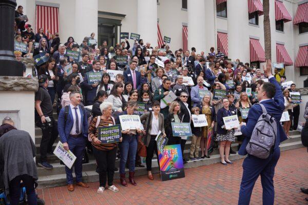 A rally leader organizes almost 200 demonstrators who attended an Equality Florida rally at the Florida Capitol in Tallahassee on March 13, 2023 to protest Gov. Ron DeSantis's "anti-woke" policies. (Dan M. Berger/The Epoch Times)