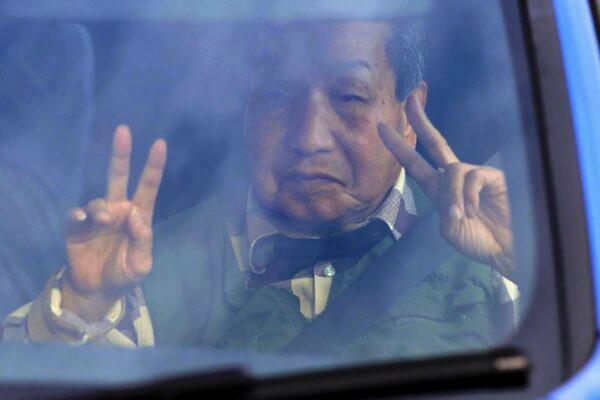 Iwao Hakamada flashes v-signs on his way back from a walk in Hamamatsu, Shizuoka prefecture, central Japan, on March 13, 2023. (Kyodo News via AP)