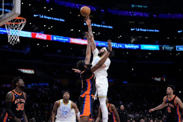 Los Angeles Lakers forward Anthony Davis, center right, shoots over New York Knicks center Mitchell Robinson during the first half of an NBA basketball game in Los Angeles on March 12, 2023. (Marcio Jose Sanchez/AP Photo)