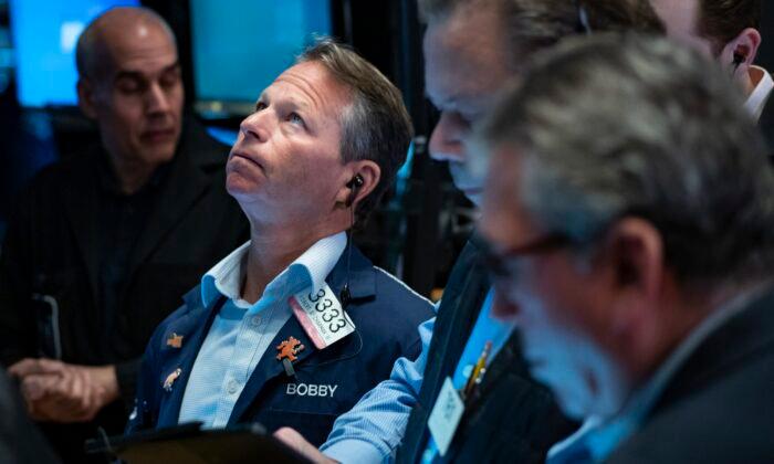 Traders work on the floor at the New York Stock Exchange on March 13, 2023. (Craig Ruttle/AP Photo)