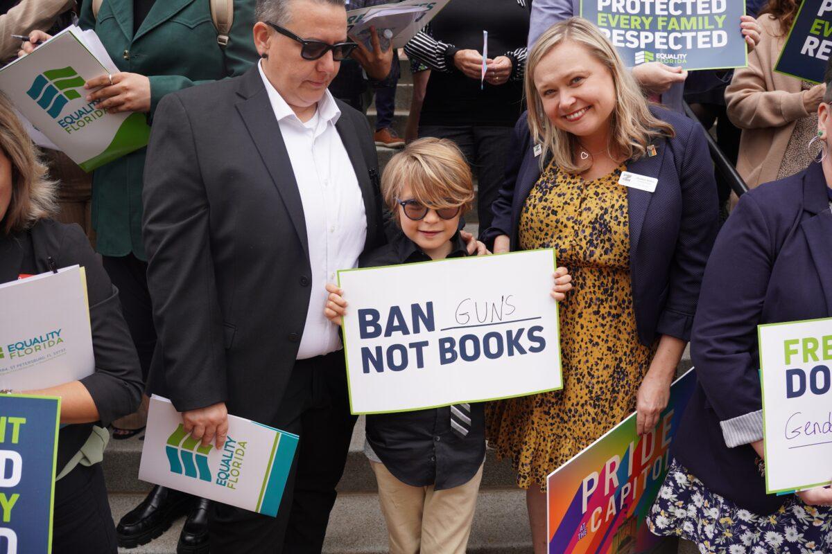 In protest of a recent push to remove overtly sexual books from public school classrooms and school libraries, a child holds a sign that reads "Ban Guns Not Books" at the Florida Capitol in Tallahassee on March 13, 2023. (Dan M. Berger/The Epoch Times)