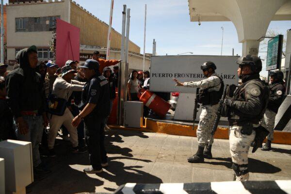 Illegal immigrants, mostly of Venezuelan origin, attempt to forcibly cross into the United States at the Paso del Norte International Bridge in Ciudad Juarez, Chihuahua state, Mexico, on March 12, 2023. (Herika Martinez/AFP via Getty Images)