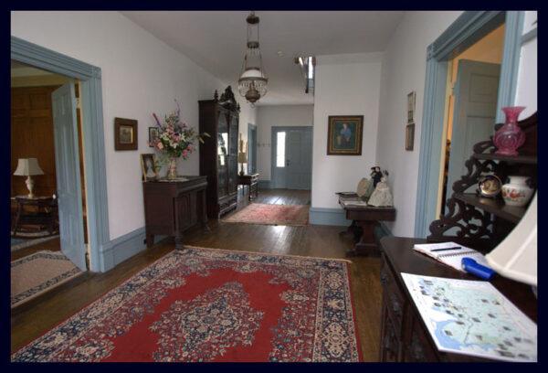 The grand upstairs and downstairs hallways of North Bend are large enough to exhibit miscellaneous multigenerational family heirlooms, photographs, and furnishings, including packed bookcases with rare and first-edition books. (Courtesy of Michael Johnson)