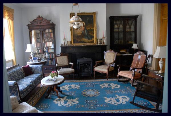 The family room features family heirlooms, original antiques and paintings, old dolls, rare books, distinct china and silver pieces, and preserved historic correspondence. Each chair in this eclectically decorated space conveys a distinct decorating style, from Mission to Victorian to Empire. (Courtesy of Michael Johnson)