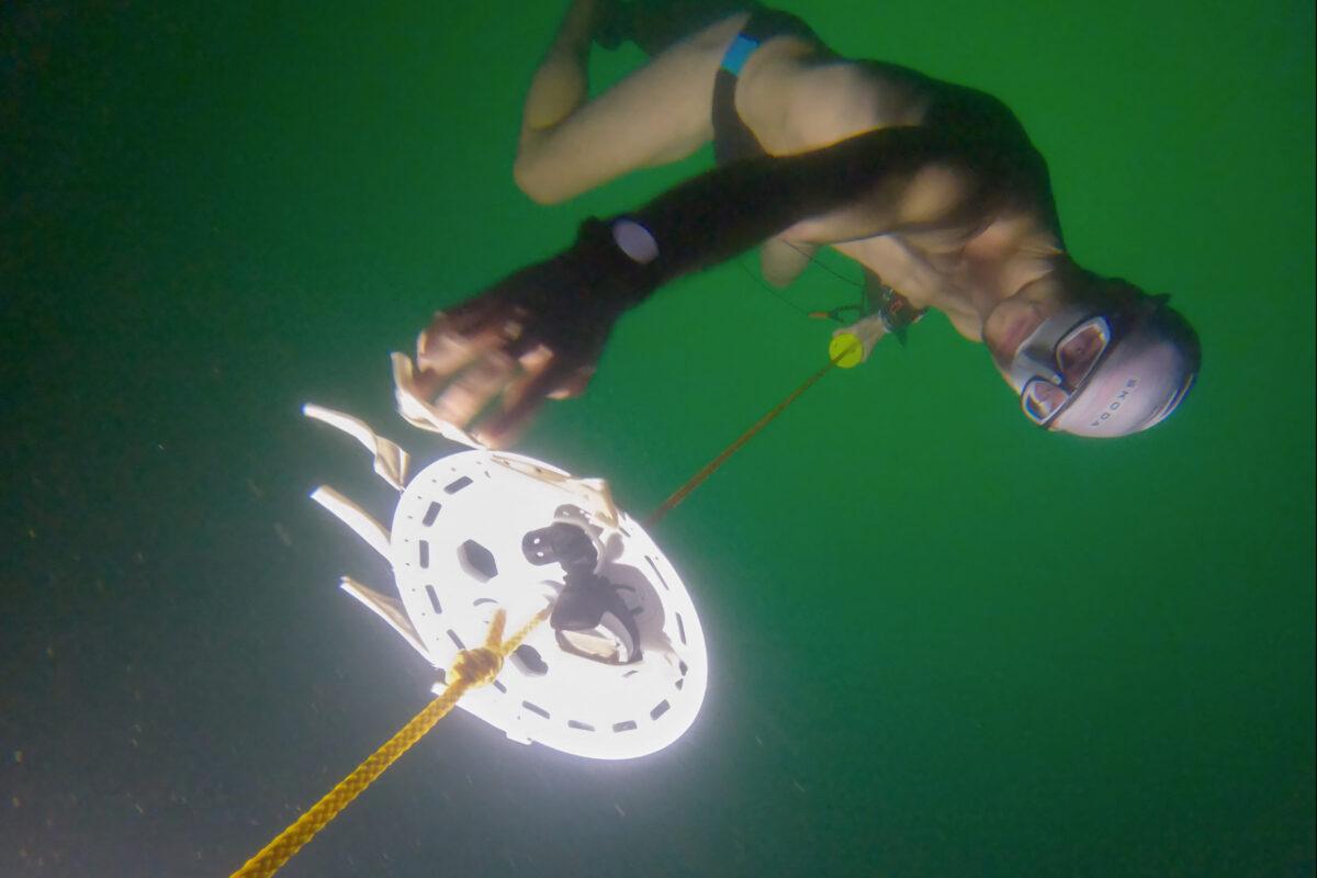 Czech free-diver David Vencl reaches 52 meters under the ice of Lake Sils in one breath and wearing only a swimsuit in this picture taken from a video in Sils near St. Moritz, Switzerland, on March 14, 2023. (David Vencl Organisation/Handout via Reuters)