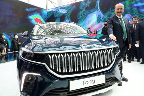 Turkey's Minister for Labor and Social Security Vedat Bilgin stands by Turkey's domestic car TOGG at the Congresium ATO in Ankara International Convention & Exhibition Center in Ankara, on March 31, 2022. (Adem Altan/AFP via Getty Images)