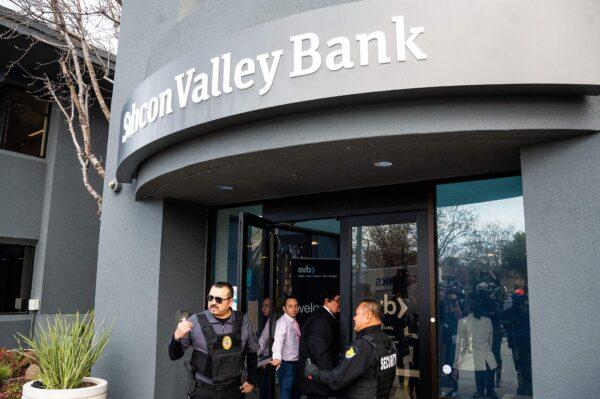 Security guards and FDIC representatives open a Silicon Valley Bank (SVB) branch for customers at SVB's headquarters in Santa Clara, Calif., on March 13, 2023. (Noah Berger/AFP via Getty Images)