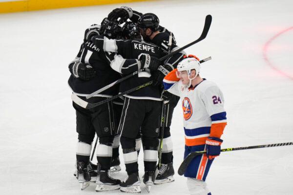 Los Angeles Kings players celebrate a goal by Drew Doughty, while New York Islanders' Scott Mayfield (24) skates past during the second period of an NHL hockey game in Los Angeles on March 14, 2023. (Jae C. Hong/AP Photo)