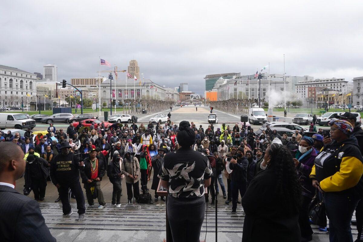 Mo "Afatasi" McNealy, middle, speaks at a reparations rally outside of City Hall in San Francisco on March 14, 2023. (Jeff Chiu/AP Photo)