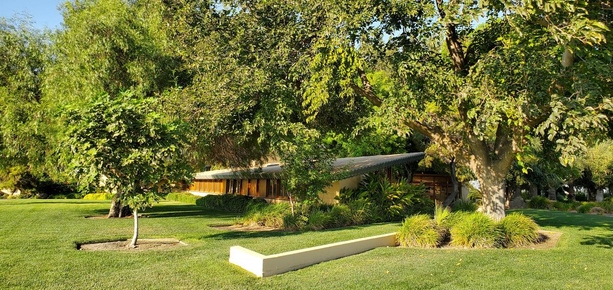 The home is shaded by a canopy of mature trees, and is designed to blend in seamlessly with the landscaping. (Courtesy of Crosby Doe)