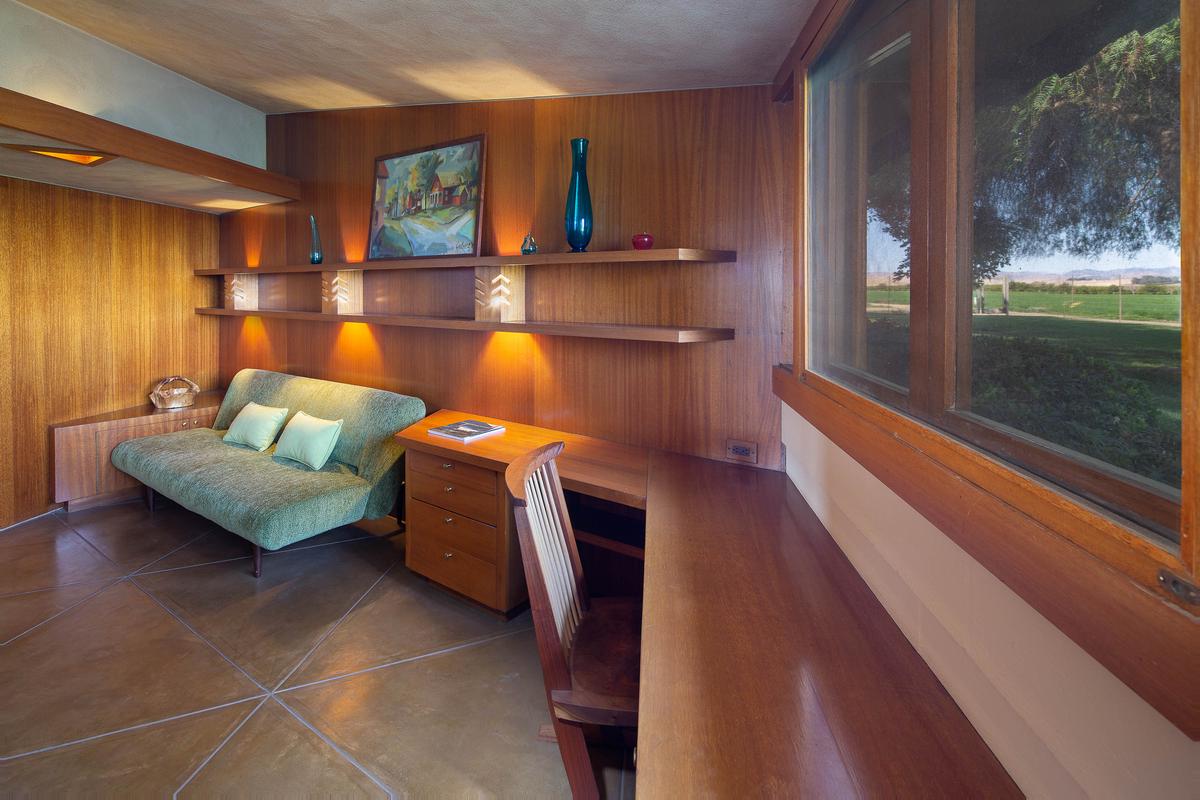 The home's office features freestanding and built-in furniture designed by Frank Lloyd Wright, as well as a great view of the surrounding countryside. (Courtesy of Crosby Doe)