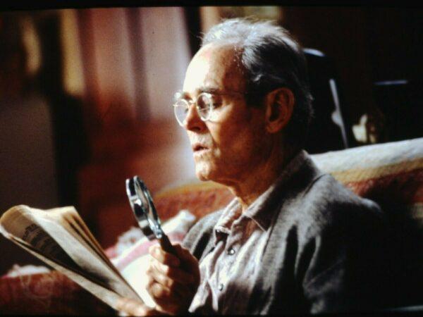 Norman (Henry Fonda) reads the classifieds with a magnifying glass, in "On Golden Pond." (MovieStillsDB)