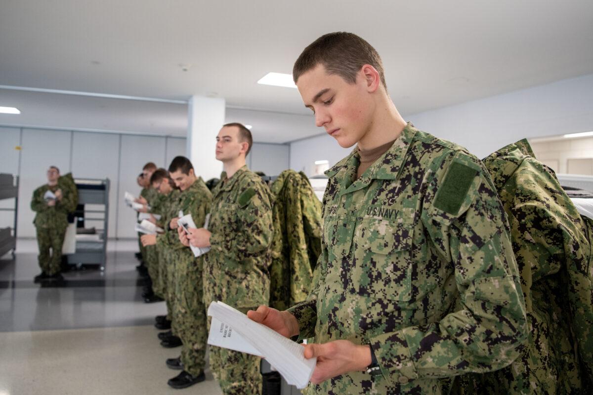 A recruit reads his Recruit Training Guide for Basic Military Training, aboard the USS Hopper, at Recruit Training Command, Great Lakes, Illinois. More than 40,000 recruits train annually at the Navy's only boot camp. (Mass Communication Specialist 1st Class Stephane Belcher, U.S. Navy)