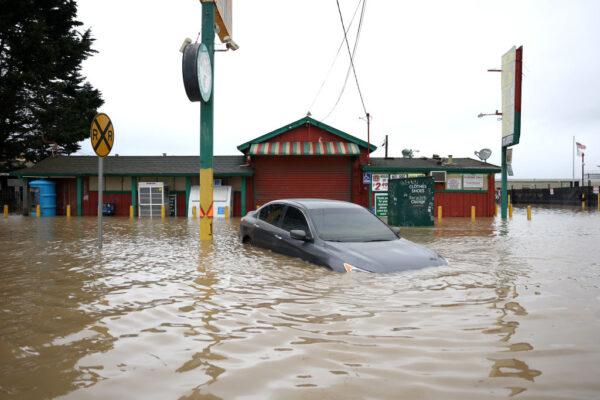 A car sits submerged in floodwaters in Pajaro, Calif., on March 14, 2023. (Justin Sullivan/Getty Images)