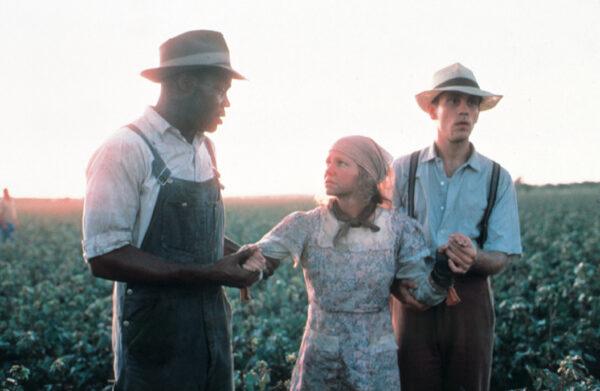(L–R) Moze (Danny Glover), Edna (Sally Field), and Mr. Will (John Malkovich) work to save the cotton crop, in "Places in the Heart." (MovieStillsDB)