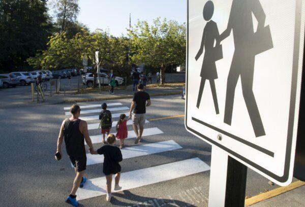 Parents walk their children to school in North Vancouver in a file photo. (The Canadian Press/Jonathan Hayward)